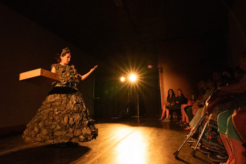 woman in costume that resembles a mountain on stage