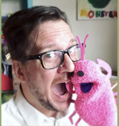 Headshot of Marty Allen with a pink sock puppet